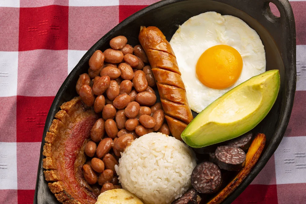 A bandeja paisa served in a cast-iron pan